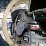 Cradled with care: A new Saab 9-5 nears completion on the assembly line. Cradled with care: A new Saab 9-5 nears completion on the assembly line.